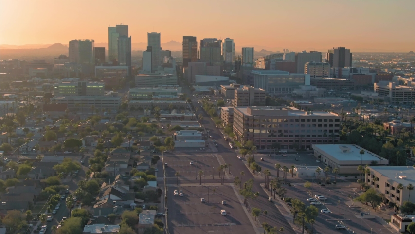 Aerial flying over downtown Phoenix city skyline at sunset. Arizona, USA 