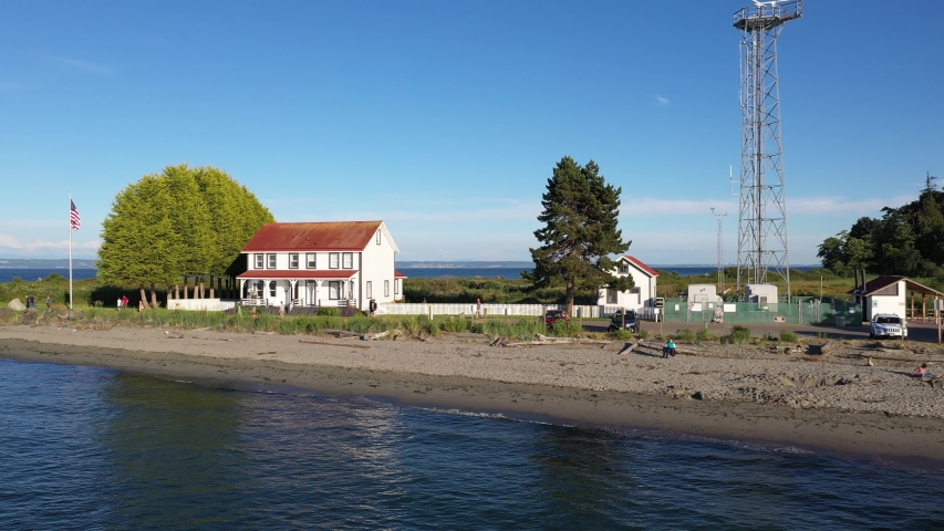 Drone footage of Point No Point Park, Puget Sound with the lighthouse and the lighthouse keeper