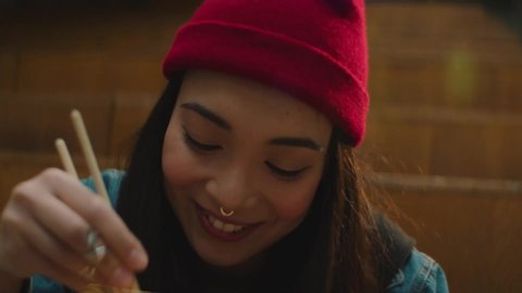 teen girl eating noodles close-up