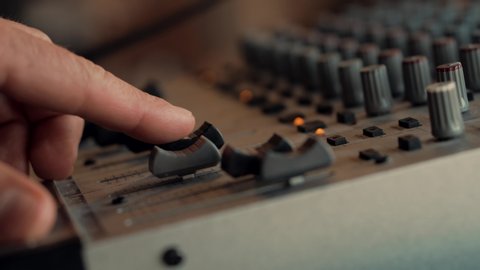 Sound Engineer Moving Sliders In Radio Station. Soundboard Pads On TV Station. Engineer Press Key Buttons On Control Desk Recording Studio. Sound Designer Used Digital Audio Mixer In Production Studio