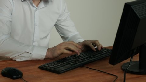 man smashes keyboard with a hammer, old equipment does not work, computer, office, workplace. Problems at work. problems with nerves, aggression, anger. psycho