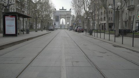 MILAN, ITALY / APRIL 2020: Arco della Pace monument in Milan, Italy during COVID-19 pandemic. Milano, Italian city and coronavirus quarantine. Empty road with no cars, traffic or people