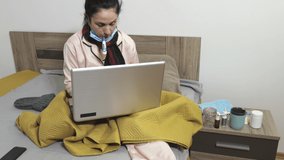 Sick woman measuring body temperature and using laptop.Work from home