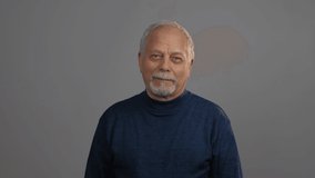 aged man with grey beard and hair nods head with enigmatic smile looking into camera close view. Concept man emotion - Powered by Shutterstock - Get 15% off with code: PIKWIZARD15