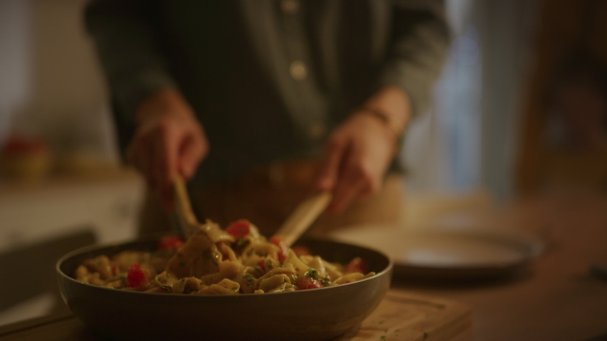 Person Serving Delicious Looking Pasta on the Plate. Serving Profesionally Cooked Pasta Dish in the Restaurant or for Romantic Dinner Meal at Home. Close-up Slow Motion Camera Shot | Shutterstock HD Video #1050644782