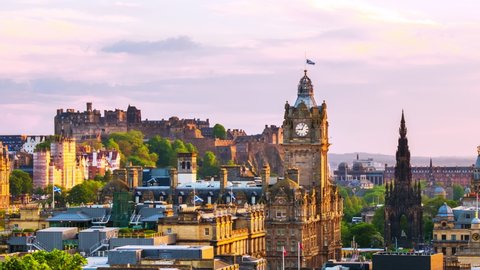 Edinburgh, UK. Aerial view of Edinburgh, Scotland. The city with Castle and Clock Tower during the evening. Cloudy sunset sky. Time-lapse at sunset, panning video
