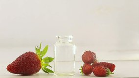 Essence of Wild strawberry on table in beautiful glass jar