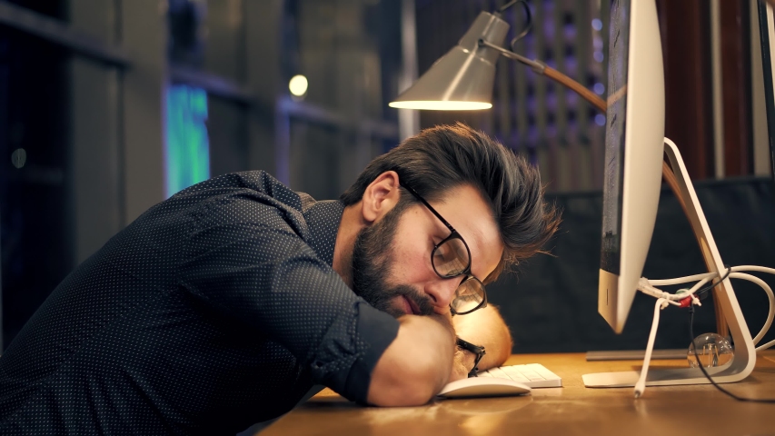Tired Businessman Sleeping On Workplace.Frustrated Businessman Working Alone.Workaholic Overtime Overworked In Internet At Deadline.Tired Businessman In Night Office.Overwhelmed Exhausted Stressed Man | Shutterstock HD Video #1050677089