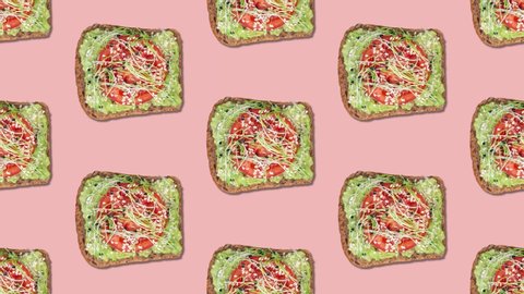 Pattern with avocado toast bite by bite stop motion. Toast with tomato, sprouts and sesame seeds. Powder pink background, healthy breakfast food concept, top view
