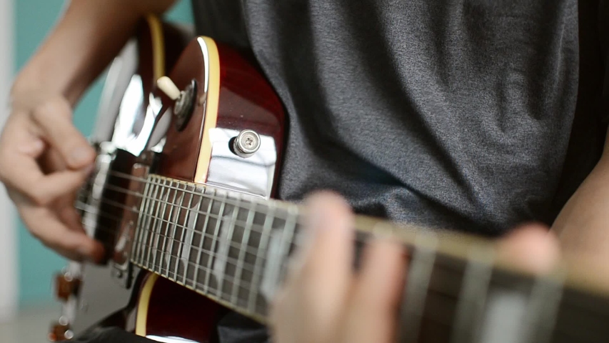 man playing electric guitar, hand close-up, music and sound.