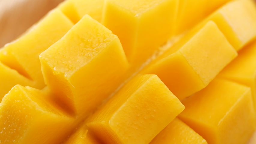 Close-up slides mangoes. Organic tropical fruits, Fresh Sliced Mango Squared rotation in 4k slow motion