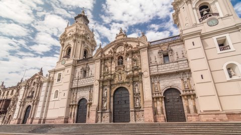 The Basilica Cathedral of Lima is a Roman Catholic cathedral located in the Plaza Mayor timelapse hyperlapse in Lima, Peru. Clouds on a blue sky