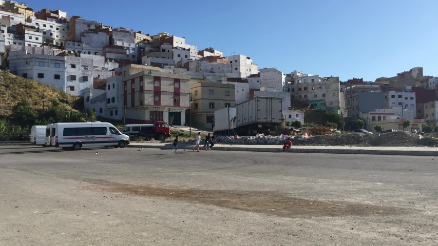 kids playing futbol in a moroccan slum