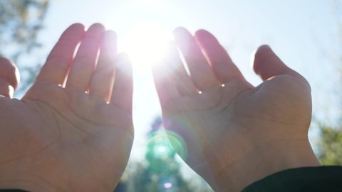 A person raises hands towards the sky and makes a prayer, Muslim prayer concept.