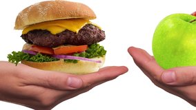 High quality video showing burger versus green and red apples, indicating healthy eating vs unhealthy eating.