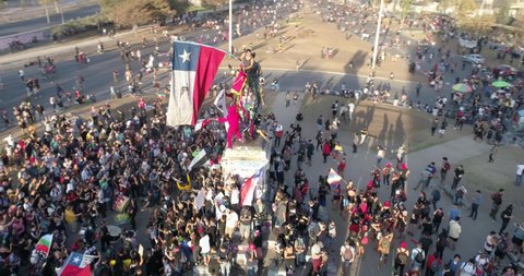 Santiago de Chile, Santiago / Chile - Circa March 2019: People crowds protesting at Santiago, Chile streets in Plaza de Italia during Chile protests. Aerial view. 4K.