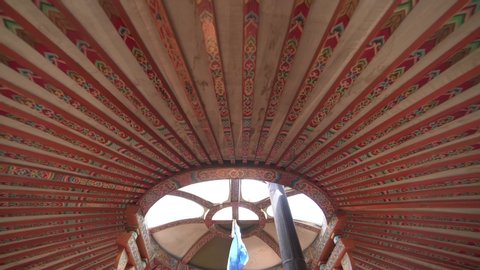 Inside a real Mongolian tent. Traditional mongol yurt interior. There is milk in the pot in the middle stove. Mongolia ger decoration decor furnishing objects equipment style elements house domestic.