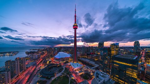 Toronto, Canada - April 09, 2020: Day to night time lapse view of Toronto cityscape including architectural landmark CN Tower in Toronto, Ontario, Canada.