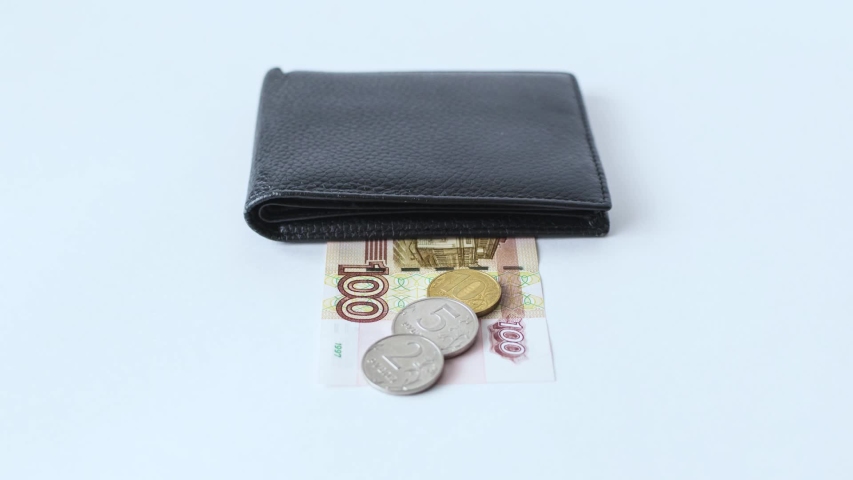 black leather wallet on various russian money on a white background. financial footage video panning or zoom