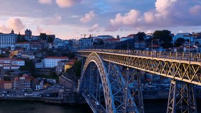 Porto, Portugal. Aerial view of Ribeira area in Porto, Portugal during a sunny evening with river, colorful buildings and bridge. Time-lapse from day to night, panning video