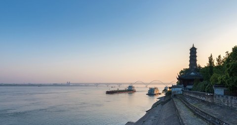 time lapse of jiujiang city landscape in the early morning, the yangtze river and ancient brick tower with bridge, jiangxi province, China