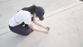 Asian young woman taking video with phone of centipede moving in the ground