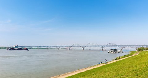time lapse of the yangtze river landscape in sunny spring, jiujiang combined bridge and grassy dykes, jiangxi province, China