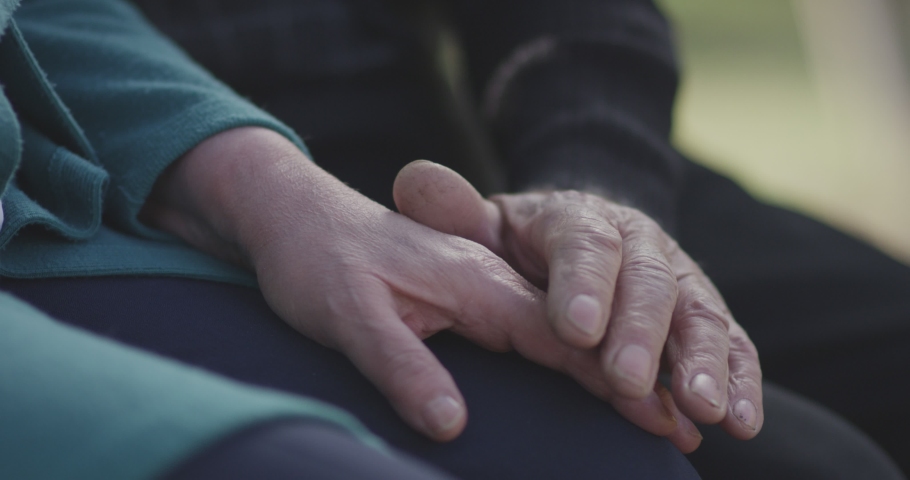 4K Faithful old couple holding hands. Close-up of hands of lovely aged couple caring and loving each other. Support trust in marriage relationship. Beautiful footage. Health care concept. Slow Motion. | Shutterstock HD Video #1050758128