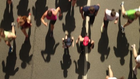 top view of blurry running people during city marathon competitions