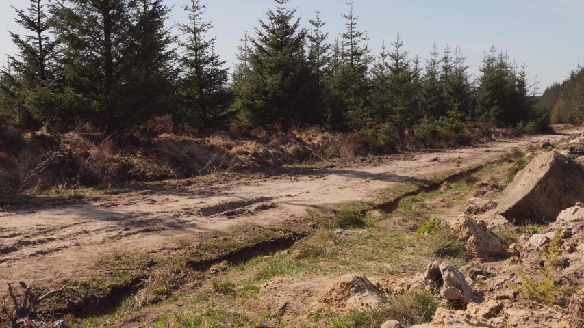 Man mountain biking on an off road dirt track in the countryside