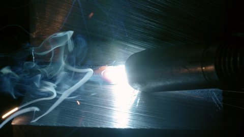 blacksmith with blowtorch steel, iron. light and lens flare slow motion