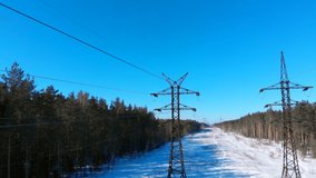Russia. winter. Aerial view from a drone. High voltage electrical line in the winter forest. Stock footage 4k