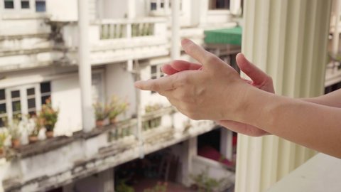 Clapping hands at balcony to show gratitude to health care worker