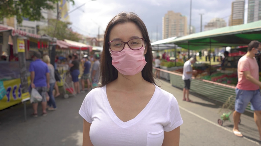 Pandemic, portrait of a young tourist woman wearing protective mask on street crowd people. the concept health and safety, N1H1 coronavirus quarantine, virus protection
 Royalty-Free Stock Footage #1050783583
