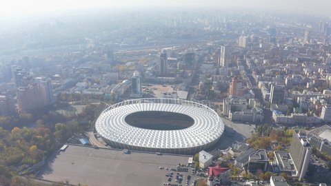 KYIV, UKRAINE - October 6, 2019. National Sports Complex "Olympic". Stadium. Flight over the football stadium, in the city of Kyiv. City landscape, summer sunny day. 