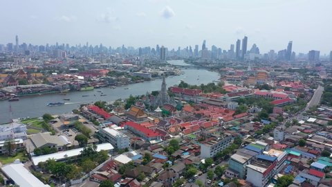 Aerial video of Wat Arun and Bangkok city skyline. Wat Arun is the old temple located near Chaophraya river in Bangkok of Thailand.