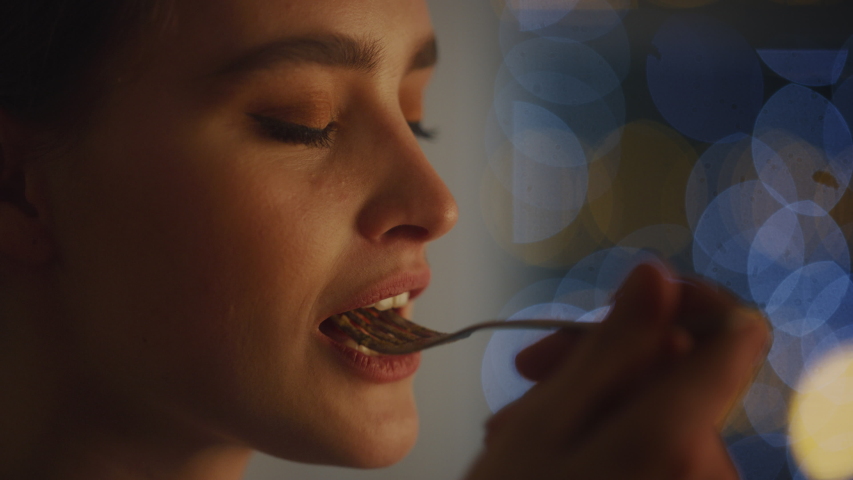 Portrait of a Beautiful Young Woman Eating Delicious Looking Pasta on the Plate. Profesionally Cooked Pasta Dish in the Restaurant or Romantic Dinner Meal at Home. Cozy Candle Light Royalty-Free Stock Footage #1050794014