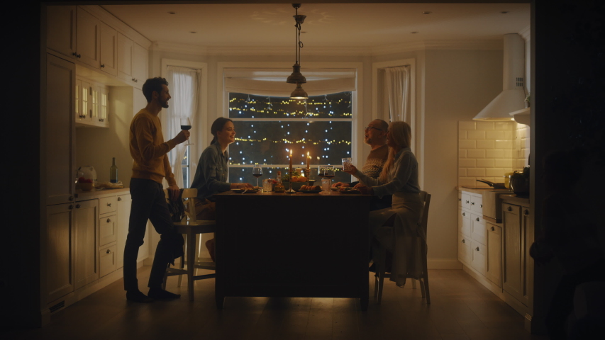 Happy Family Celebrating together, Sitting at the Table Eating Delicious Dinner Meal. Little Child, Young Husband, Wife, Grandfather and Grandmother, Telling Stories, Joking, Having Fun, Being Joyful