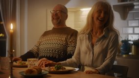 Happy Senior Couple in Love Have Romantic Evening, Eating Delicious Dinner Meal in the Kitchen, Celebrating Anniversary. Elderly Lovely Husband and Wife Have Romantic Evening with Wine - Powered by Shutterstock - Get 15% off with code: PIKWIZARD15
