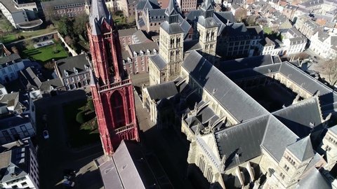 Aerial view of downtown Maastricht Saint John's tower and Basilica of St. Servatius is Roman Catholic church in old city centre located at towns main square the Vrijthof 4k high resolution footage