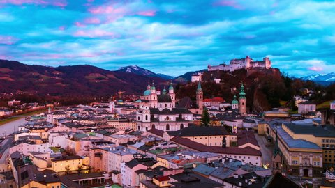 Salzburg, Austria. Aerial view of popular destination city in Austria - Salzburg at sunset. Castle and Cathedral with mountain at the background, zoom