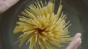 hands holding spaghetti put in boiling water cooking - Powered by Shutterstock - Get 15% off with code: PIKWIZARD15