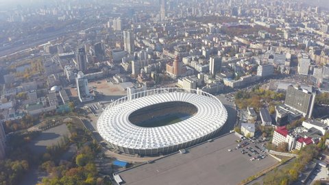 KYIV, UKRAINE - October 6, 2019. National Sports Complex "Olympic". Stadium. Flight over the football stadium, in the city of Kyiv. City landscape, summer sunny day. 