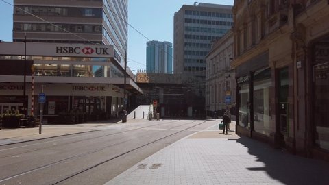 BIRMINGHAM, UK - 2020: Empty streets in Birmingham City centre during coronavirus lockdown with man wearing mask near Grand Central station