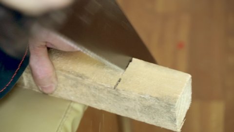 Hand saw on wood. Hacksaw. Sawing wood hacksaw. Close-up