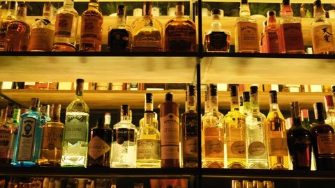 Kyiv, Ukraine - March, 2020: Luxury liquors collection in a pub, bar, club or restaurant. Alcohol bottles on the shelves inside the bar room area. Vodka, Gin, Whisky, Brandy, Rum 4k