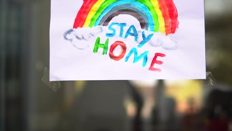 Child's Rainbow Painting With Stay Home Message During Coronavirus.