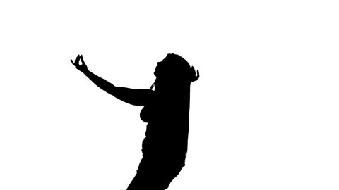 Medium long shot of a young beautiful dancer dancing belly dance, oriental dance, exotic dance, black silhouette on a white background