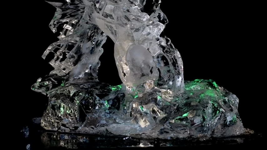 Ice sculpture. closeup upward pan shot of ice eagle head with black background Royalty-Free Stock Footage #1050837988