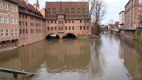 historic hospital building on the river in the ancient Bavarian city of Nuremberg, river water flows, touristic, architectural concept